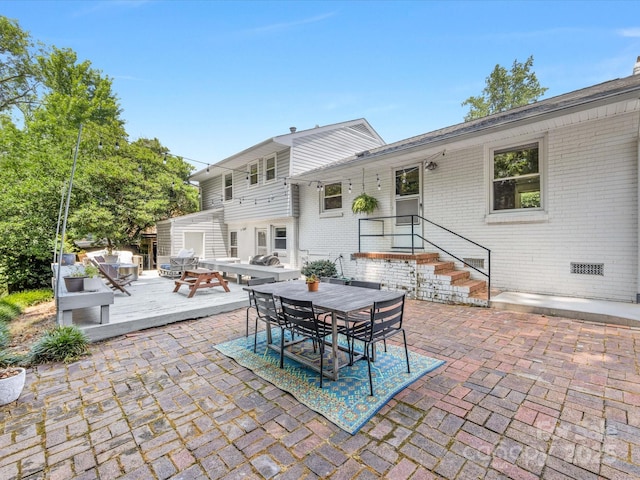 3200 Spring Valley Rd, Charlotte, NC 28210 - back of house with outdoor dining area, brick siding, a patio, and a wooden deck