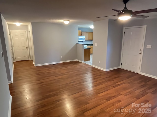 1015 Piney Church Rd, Concord, NC 28025 - unfurnished living room with a ceiling fan and dark wood finished floors