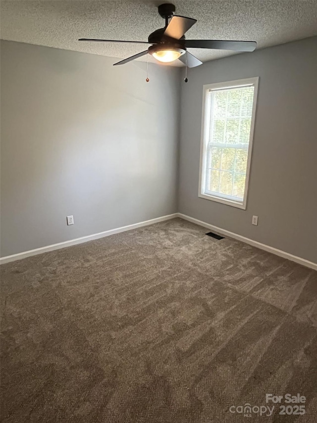 1015 Piney Church Rd, Concord, NC 28025 - empty room featuring a textured ceiling, ceiling fan, and dark colored carpet