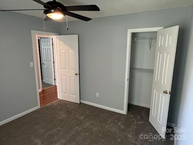1015 Piney Church Rd, Concord, NC 28025 - unfurnished bedroom with dark carpet, a closet, and ceiling fan