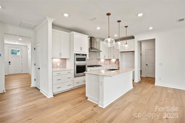 9511 Coast Laurel Ave NW, Concord, NC 28027 - kitchen featuring wall chimney exhaust hood, tasteful backsplash, double oven, light wood-style floors, and ornamental molding