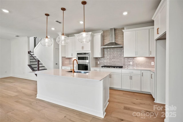 9511 Coast Laurel Ave NW, Concord, NC 28027 - kitchen with wall chimney exhaust hood, stainless steel double oven, gas stovetop, light countertops, and tasteful backsplash