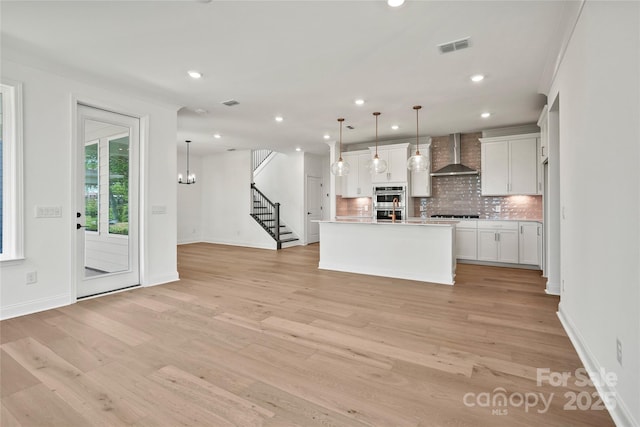 9511 Coast Laurel Ave NW, Concord, NC 28027 - kitchen featuring wall chimney exhaust hood, backsplash, recessed lighting, light wood-style flooring, and white cabinetry
