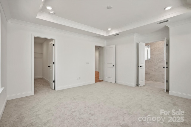 9511 Coast Laurel Ave NW, Concord, NC 28027 - unfurnished bedroom featuring ornamental molding, recessed lighting, carpet, a tray ceiling, and a walk in closet