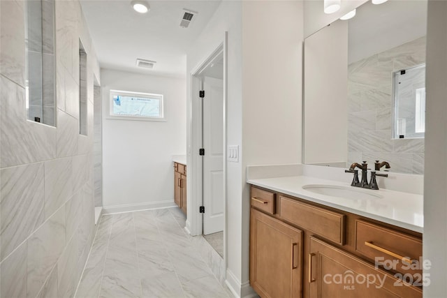 9511 Coast Laurel Ave NW, Concord, NC 28027 - bathroom featuring vanity, marble look tile flooring, and a walk in shower