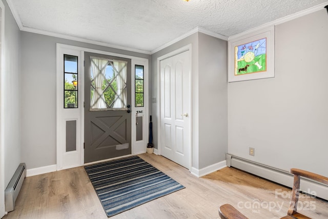 1058 Howard Gap Loop Rd, Flat Rock, NC 28731 - foyer featuring a baseboard heating unit, wood finished floors, a textured ceiling, and crown molding