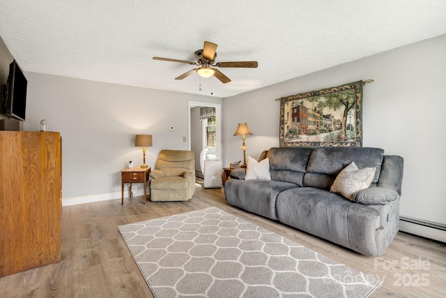 1058 Howard Gap Loop Rd, Flat Rock, NC 28731 - living room featuring ceiling fan, wood finished floors, and a textured ceiling