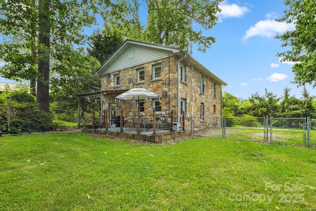 1058 Howard Gap Loop Rd, Flat Rock, NC 28731 - rear view of house featuring stone siding, a gate, and a patio area