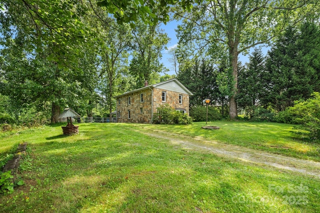 1058 Howard Gap Loop Rd, Flat Rock, NC 28731 - view of green lawn with an outdoor fire pit and view of scattered trees