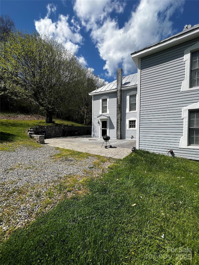 4606 Garvey Bridge Rd, Crumpler, NC 28617 - rear view of house with a patio area, a standing seam roof, a lawn, and a metal roof