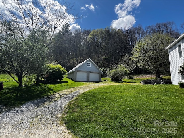 4606 Garvey Bridge Rd, Crumpler, NC 28617 - view of grassy yard featuring a detached garage and an outdoor structure