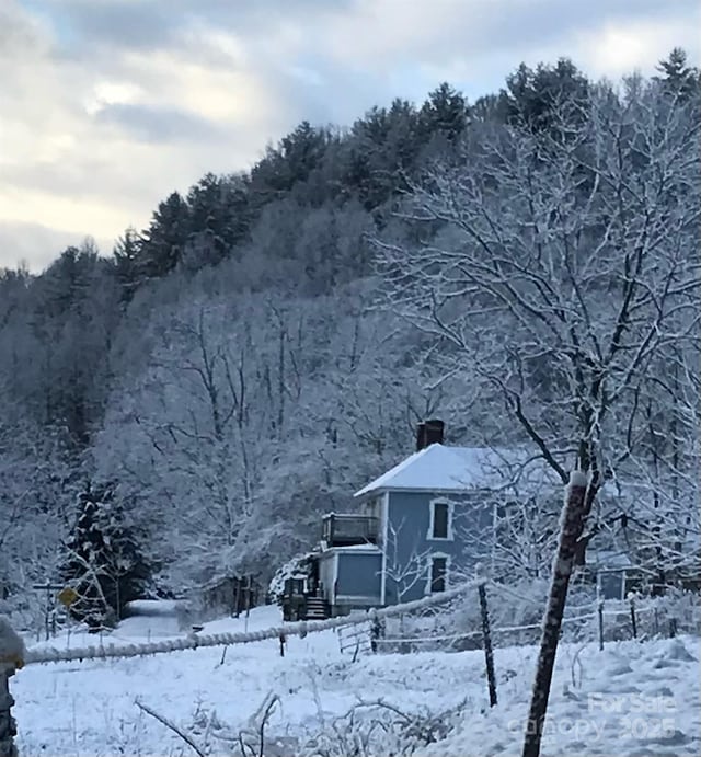 4606 Garvey Bridge Rd, Crumpler, NC 28617 - snow covered property with a chimney and a wooded view