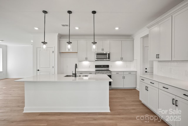 9515 Coast Laurel Ave NW, Concord, NC 28027 - kitchen with stainless steel appliances, tasteful backsplash, light countertops, hanging light fixtures, and recessed lighting