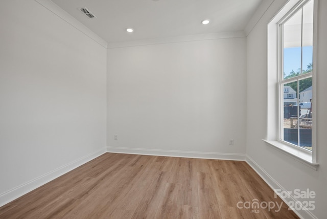 9515 Coast Laurel Ave NW, Concord, NC 28027 - empty room featuring light wood-style flooring, recessed lighting, and crown molding