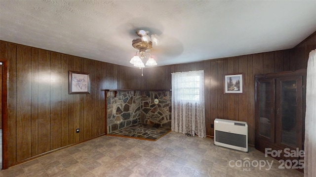 560 Bailey Mountain Rd, Mars Hill, NC 28754 - unfurnished living room with heating unit, a ceiling fan, wood walls, and tile patterned floors