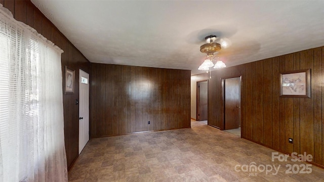 560 Bailey Mountain Rd, Mars Hill, NC 28754 - unfurnished bedroom featuring wood walls and a ceiling fan