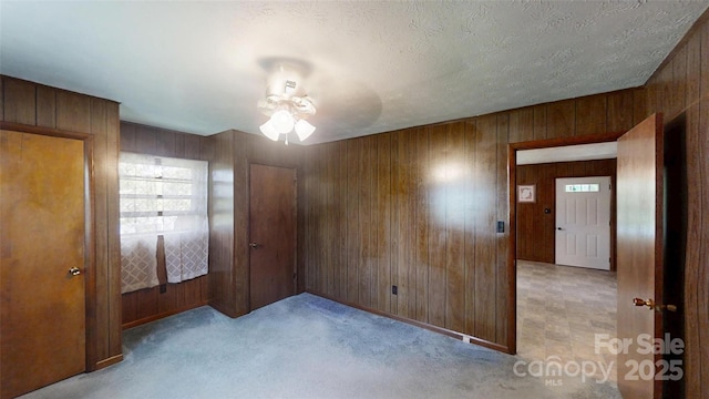 560 Bailey Mountain Rd, Mars Hill, NC 28754 - carpeted empty room featuring wood walls and a ceiling fan