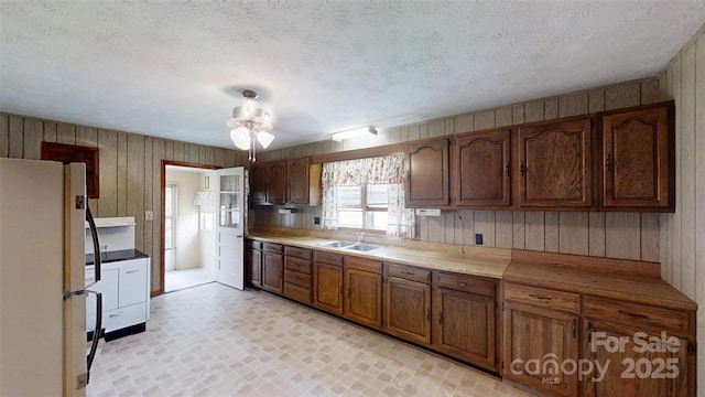 560 Bailey Mountain Rd, Mars Hill, NC 28754 - kitchen with freestanding refrigerator, wood walls, and a ceiling fan