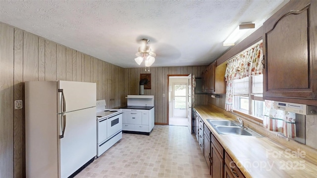 560 Bailey Mountain Rd, Mars Hill, NC 28754 - kitchen with white appliances, ceiling fan, light countertops, a textured ceiling, and wood walls
