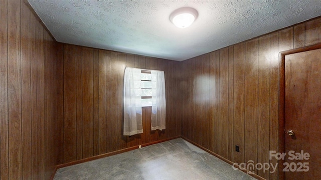 560 Bailey Mountain Rd, Mars Hill, NC 28754 - carpeted spare room with wooden walls and a textured ceiling