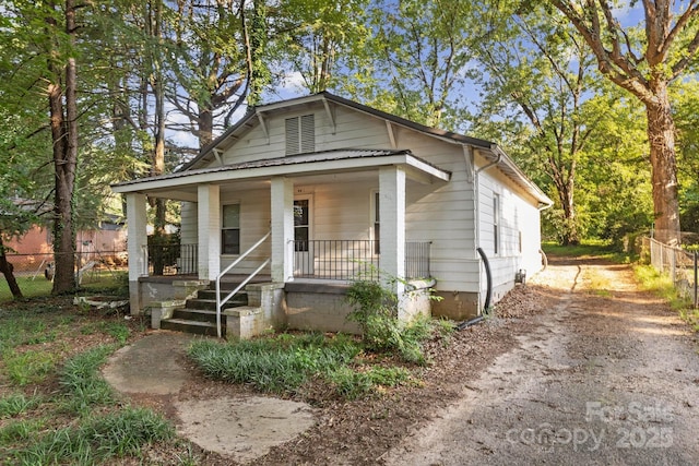 709 E Front St, Statesville, NC 28677 - shotgun-style home featuring a porch and driveway