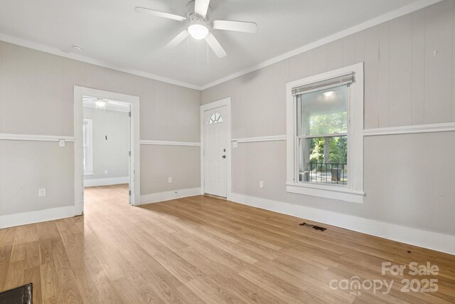 709 E Front St, Statesville, NC 28677 - empty room featuring ornamental molding, ceiling fan, and wood finished floors