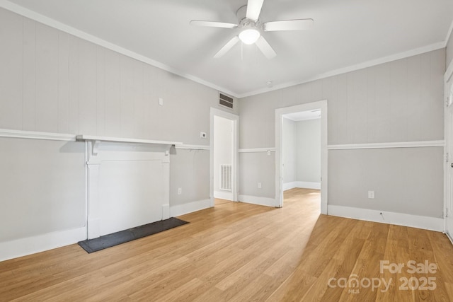 709 E Front St, Statesville, NC 28677 - unfurnished living room with a ceiling fan, light wood finished floors, and crown molding