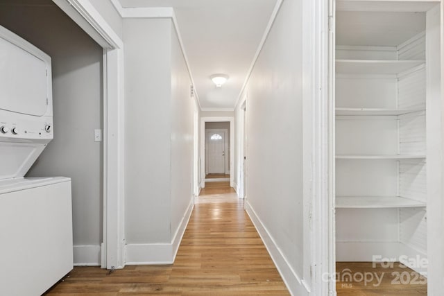 709 E Front St, Statesville, NC 28677 - hall featuring stacked washer / drying machine, light wood-type flooring, and ornamental molding