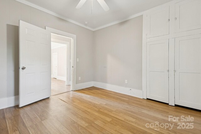 709 E Front St, Statesville, NC 28677 - unfurnished bedroom with crown molding, light wood finished floors, and a ceiling fan