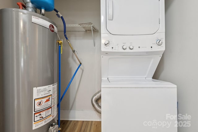709 E Front St, Statesville, NC 28677 - washroom featuring gas water heater, stacked washer / dryer, and wood finished floors