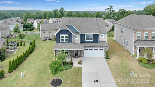 2309 Abundance Ln, Waxhaw, NC 28173 - view of front of house with driveway, an attached garage, stone siding, and a residential view