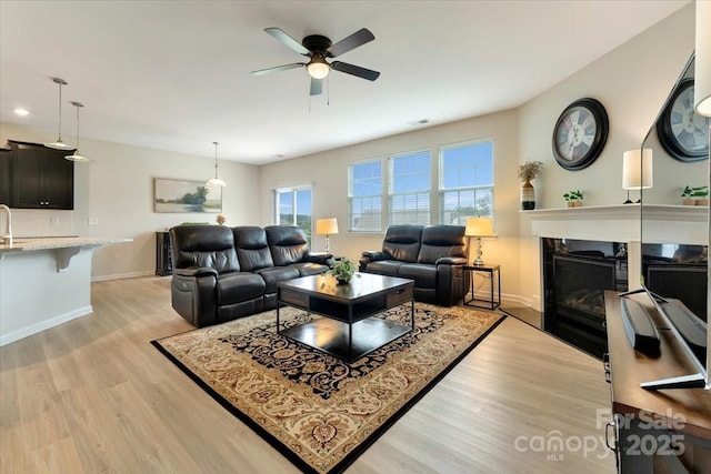 2309 Abundance Ln, Waxhaw, NC 28173 - living room with a ceiling fan, light wood-style floors, and a fireplace