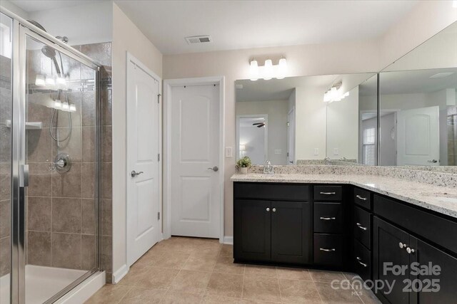 2309 Abundance Ln, Waxhaw, NC 28173 - full bath featuring double vanity, a shower stall, and tile patterned flooring