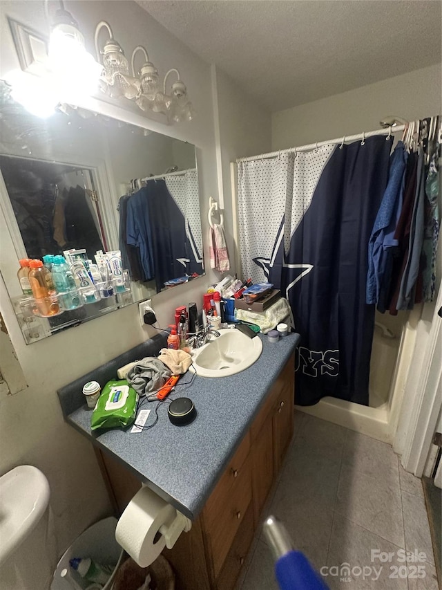 801 Tryon St, Shelby, NC 28150 - full bathroom with vanity, curtained shower, a textured ceiling, and tile patterned flooring
