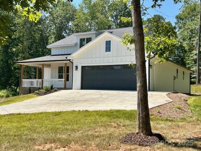 141 Maplewood Ct, Hudson, NC 28638 - modern farmhouse featuring concrete driveway, covered porch, board and batten siding, an attached garage, and a front lawn