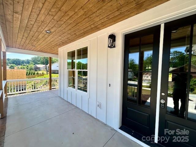 141 Maplewood Ct, Hudson, NC 28638 - view of exterior entry featuring board and batten siding and a porch