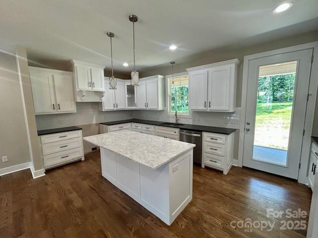 141 Maplewood Ct, Hudson, NC 28638 - kitchen with stainless steel dishwasher, dark wood-type flooring, white cabinets, pendant lighting, and a kitchen island