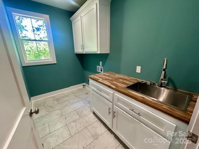 141 Maplewood Ct, Hudson, NC 28638 - laundry area with light marble finish floors, hookup for a washing machine, and cabinet space
