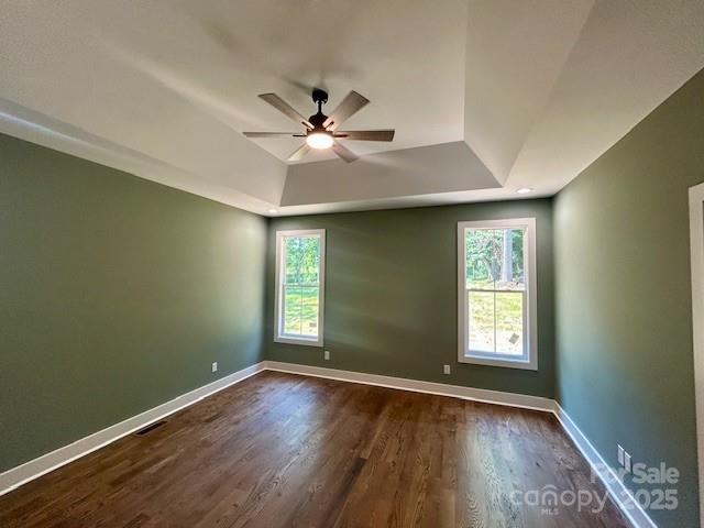 141 Maplewood Ct, Hudson, NC 28638 - empty room featuring a raised ceiling, ceiling fan, plenty of natural light, and dark wood-style floors