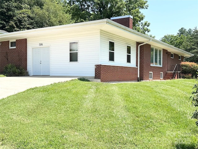 1586 Echo Dr, Lenoir, NC 28645 - view of front facade featuring a chimney, brick siding, and a front lawn