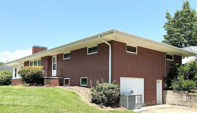 1586 Echo Dr, Lenoir, NC 28645 - view of home's exterior featuring a lawn, a chimney, and brick siding