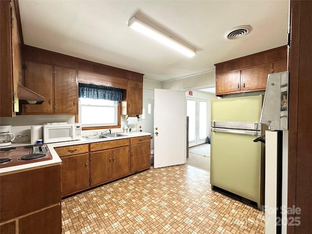1586 Echo Dr, Lenoir, NC 28645 - kitchen featuring white microwave, electric cooktop, light flooring, wall chimney range hood, and light countertops