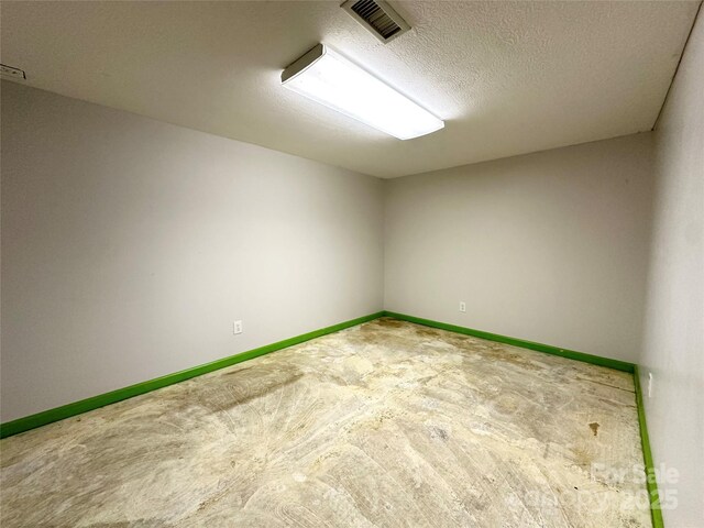 1586 Echo Dr, Lenoir, NC 28645 - spare room featuring carpet floors and a textured ceiling