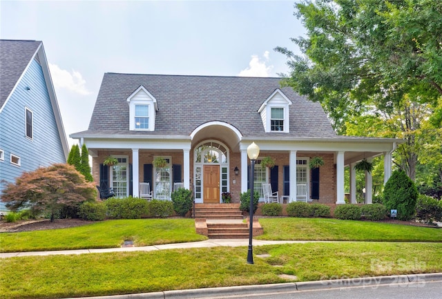 5604 Yorke St NW, Concord, NC 28027 - cape cod house with covered porch, a front yard, and brick siding
