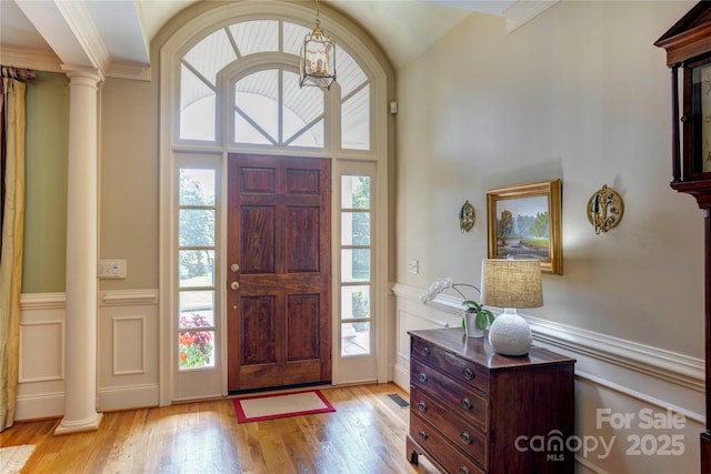5604 Yorke St NW, Concord, NC 28027 - foyer with wainscoting, wood finished floors, decorative columns, and crown molding