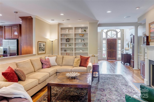 5604 Yorke St NW, Concord, NC 28027 - living area with crown molding, light wood-style flooring, built in shelves, recessed lighting, and decorative columns