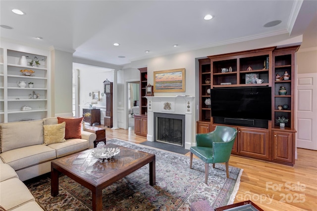 5604 Yorke St NW, Concord, NC 28027 - living area featuring a fireplace with flush hearth, light wood-style flooring, crown molding, built in shelves, and recessed lighting