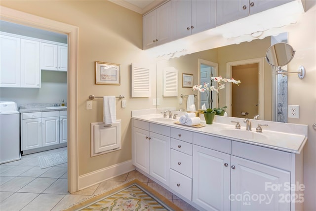 5604 Yorke St NW, Concord, NC 28027 - bathroom with washer / clothes dryer, tile patterned flooring, and double vanity