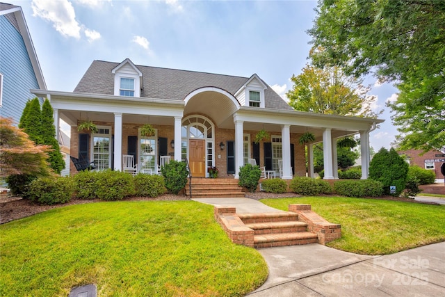 5604 Yorke St NW, Concord, NC 28027 - view of front facade with covered porch, brick siding, a front lawn, and roof with shingles
