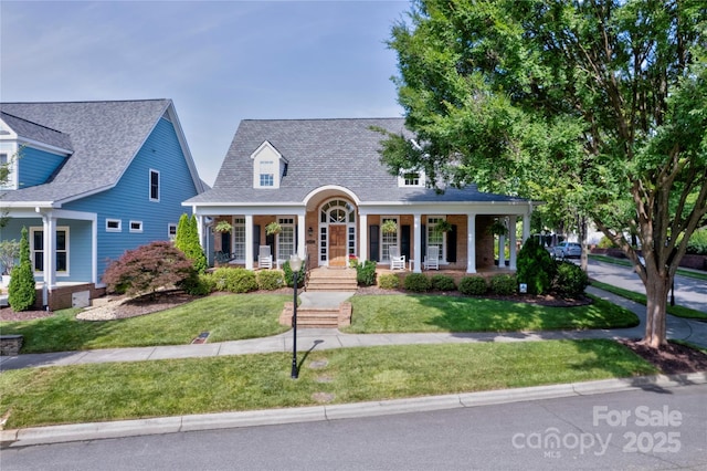 5604 Yorke St NW, Concord, NC 28027 - cape cod-style house featuring a porch, a front lawn, and a shingled roof